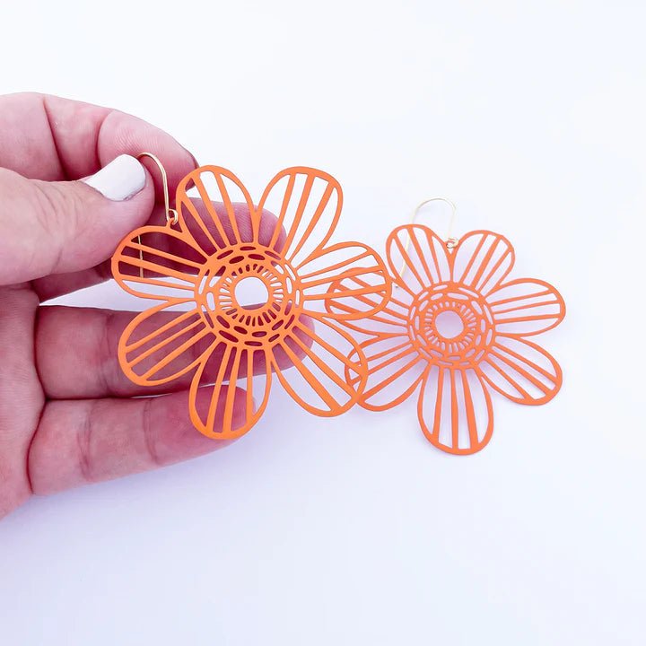 DENZ BIG Flowers in Orange earrings, held by hand