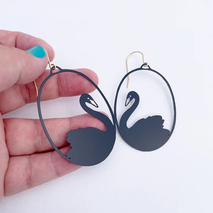 DENZ Black Swans, held by hand