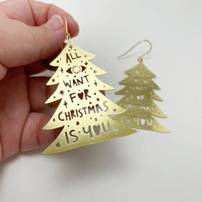 DENZ Christmas Trees in gold, held by hand