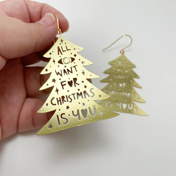 DENZ Christmas Trees in gold, held by hand