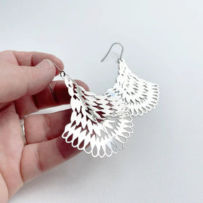 DENZ Essence dangles in silver, held by hand