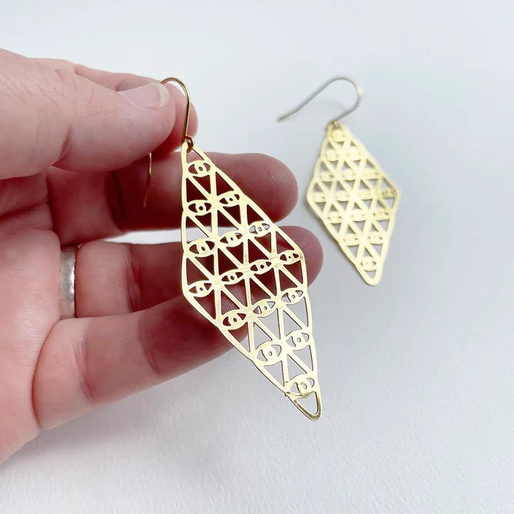 DENZ Kaleidoscope dangles in gold, held by hand