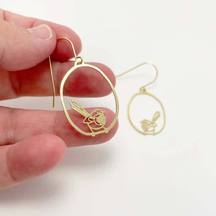 DENZ Mini Fairy wren dangles in gold, held by hand