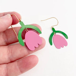 DENZ Mini Lazy Tulips in Emerald and Bubblegum earrings, held by hand