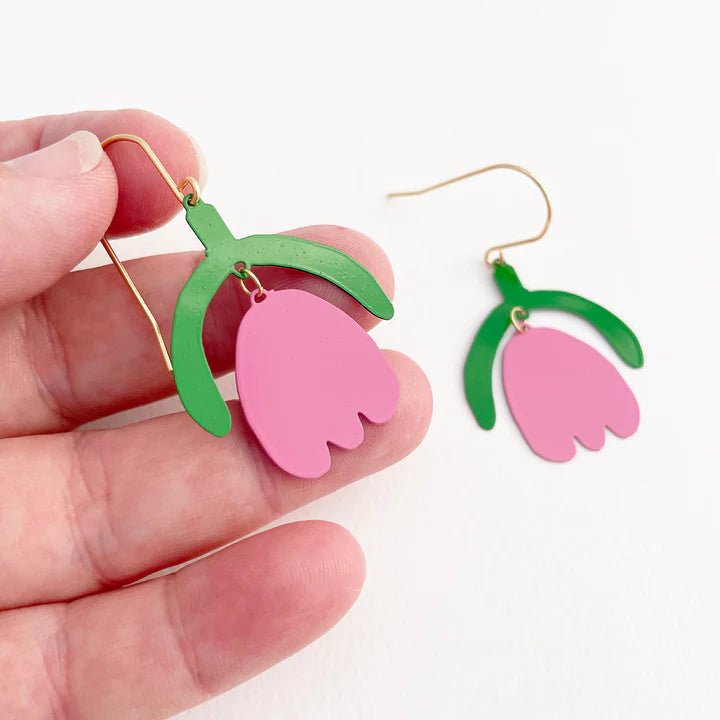 DENZ Mini Lazy Tulips in Emerald and Bubblegum earrings, held by hand