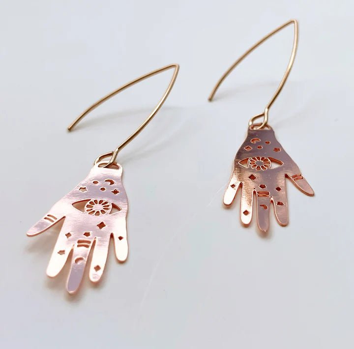 DENZ Mini Magic hand dangles in rose gold, angled view
