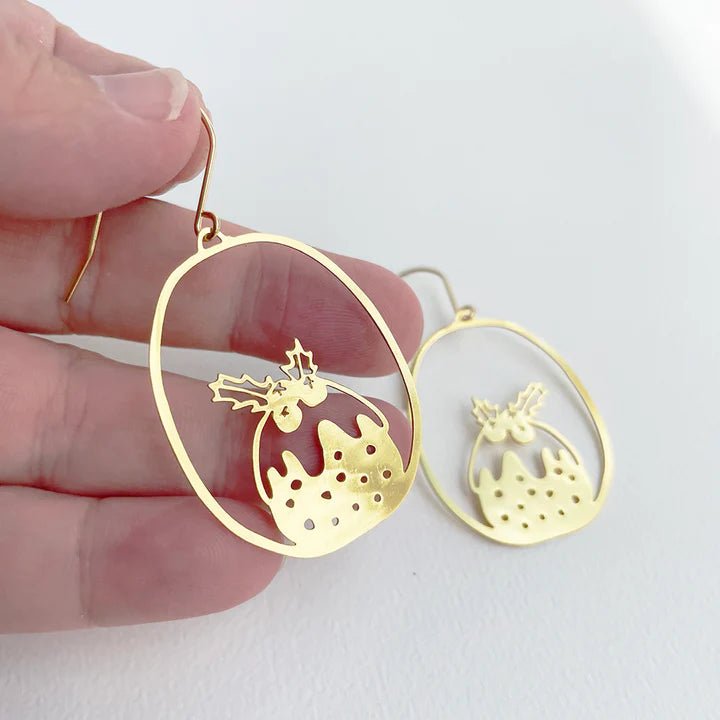 DENZ Mini Puddings in Gold earrings, held by hand