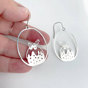 DENZ Mini Puddings in Silver earrings, held by hand
