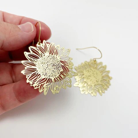 DENZ Mini Sunflower dangles in gold, held by hand