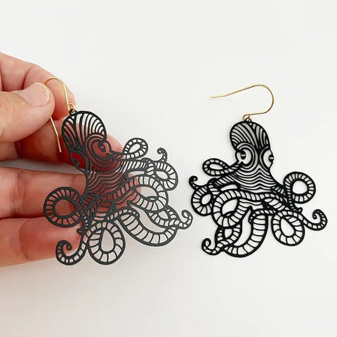 DENZ Octopus dangles in black, held by hand