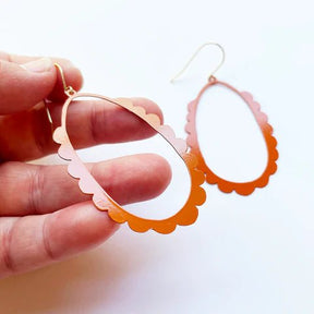 DENZ Scallop Hoops in burnt orange - painted steel dangles, held by hand