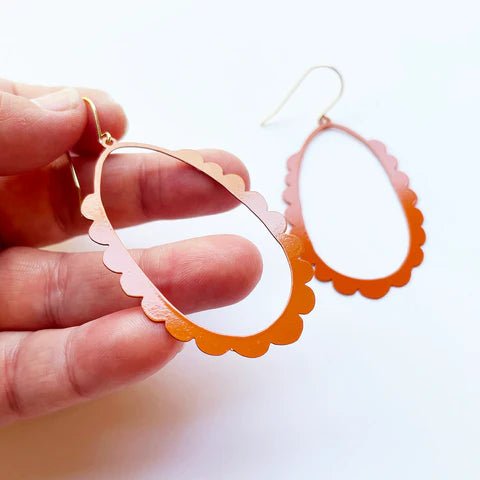 DENZ Scallop Hoops in burnt orange - painted steel dangles, held by hand