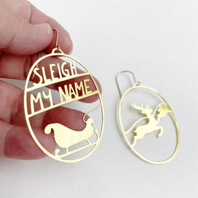 DENZ Sleigh My Name in Gold earings, held by hand