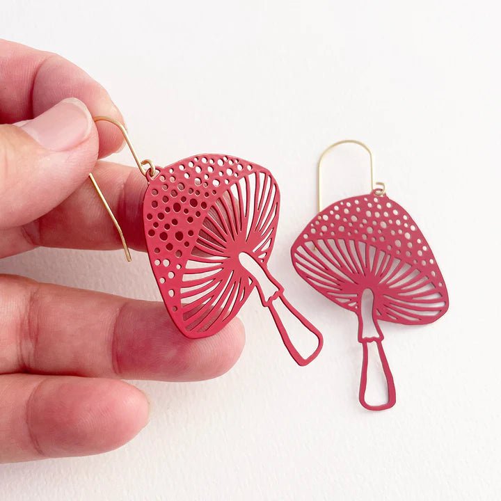 DENZ Toadstools in red earrings, held by hand