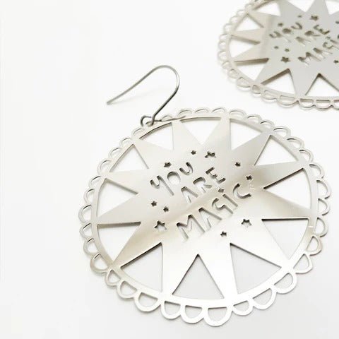 DENZ You Are Magic in silver earrings, angled view