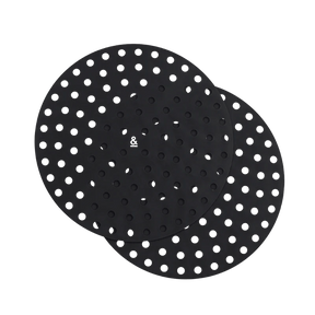 Seed & Sprout round silicone air fryer mat set of two in black, featuring a perforated mesh design for optimal air circulation.
