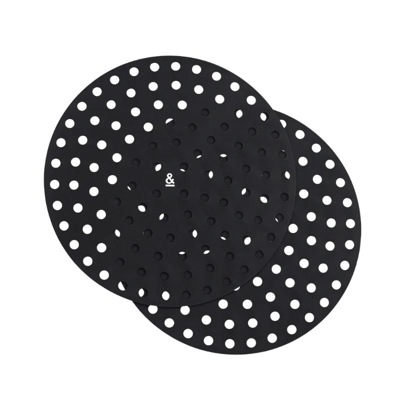 Seed & Sprout round silicone air fryer mat set of two in black, featuring a perforated mesh design for optimal air circulation.