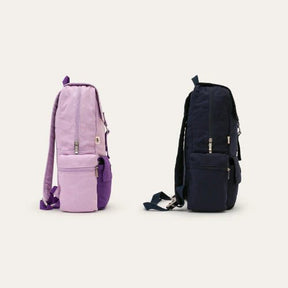 Seed & Sprout organic cotton backpacks displayed side-by-side in soft plum and deep ocean blue colorway.