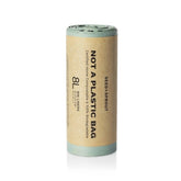 Seed & Sprout roll of 8L sage green compostable bin liners wrapped in a kraft paper sleeve stating "Not A Plastic Bag".