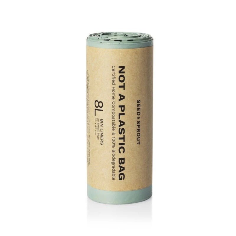 Seed & Sprout roll of 8L sage green compostable bin liners wrapped in a kraft paper sleeve stating "Not A Plastic Bag".