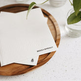 Seed & Sprout cellulose sponge cloth set of 2 in cloud white featuring clean black logo branding.