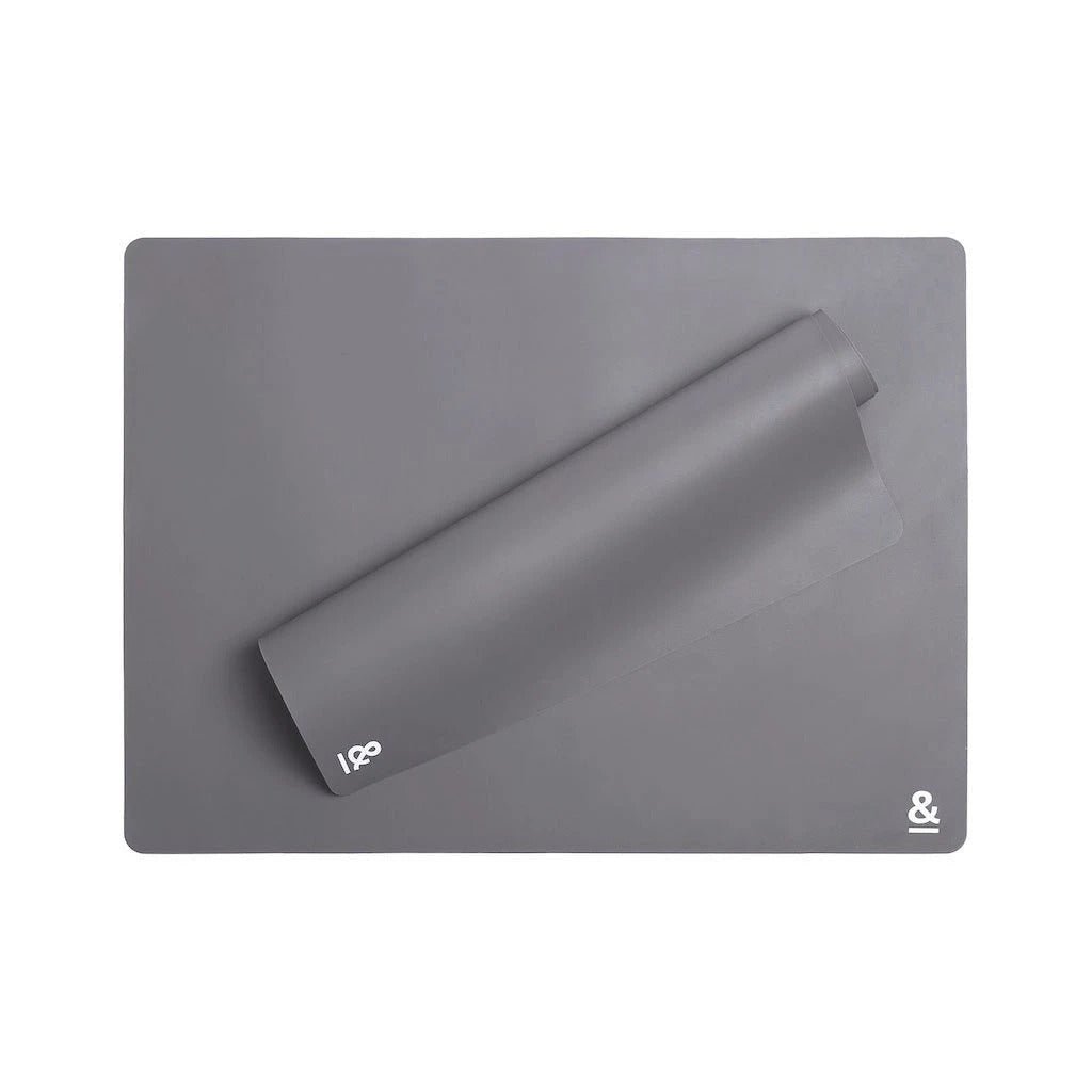 Flat overhead studio shot of Seed & Sprout non-stick graphite silicone baking sheets showing smooth surface texture and corner branding.