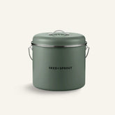 Seed & Sprout kitchen compost bin in a muted eucalyptus green finish featuring a vented lid and side handle.