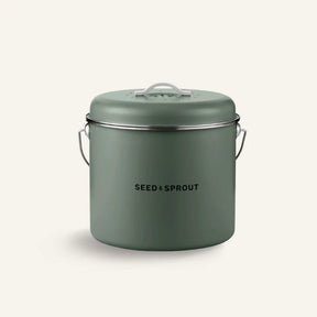 Seed & Sprout kitchen compost bin in a muted eucalyptus green finish featuring a vented lid and side handle.