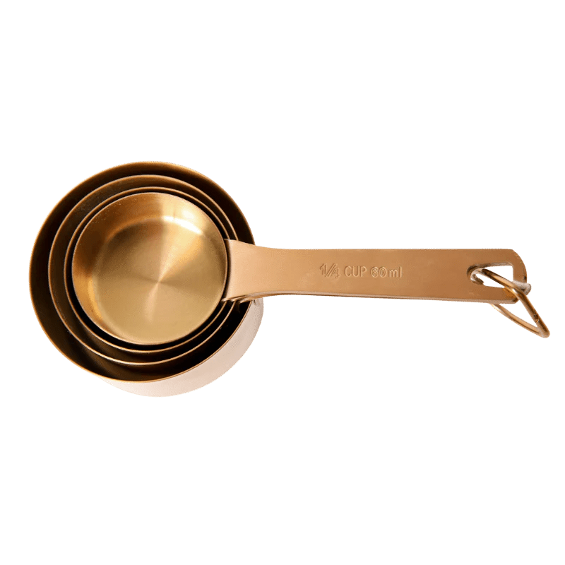 Seed & Sprout nesting metal measuring cup set in a warm bronze finish, securely stacked together on a removable storage ring.