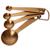 Seed & Sprout brass-toned stainless steel measuring spoon set of four linked on a removable ring.