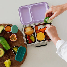 Seed & Sprout Mini CrunchBox stainless steel lunch box open to show two divided internal compartments and an orchid silicone-lined lid.