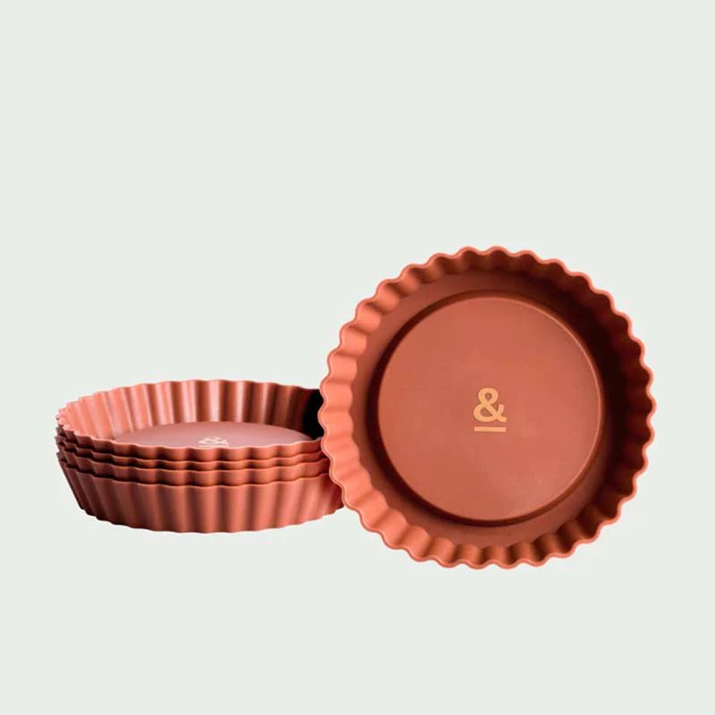 Seed & Sprout mini pie dish set of 4 in a warm terracotta tone, featuring a stacked column and a single dish displaying the brand's "&" logo.