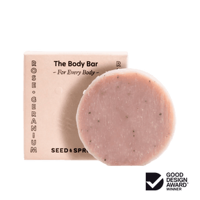 Seed & Sprout "The Body Bar" in Rose Geranium placed in front of its matching pink packaging box.