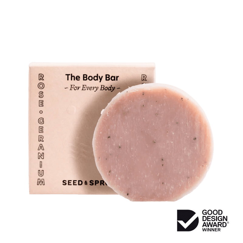 Seed & Sprout "The Body Bar" in Rose Geranium placed in front of its matching pink packaging box.
