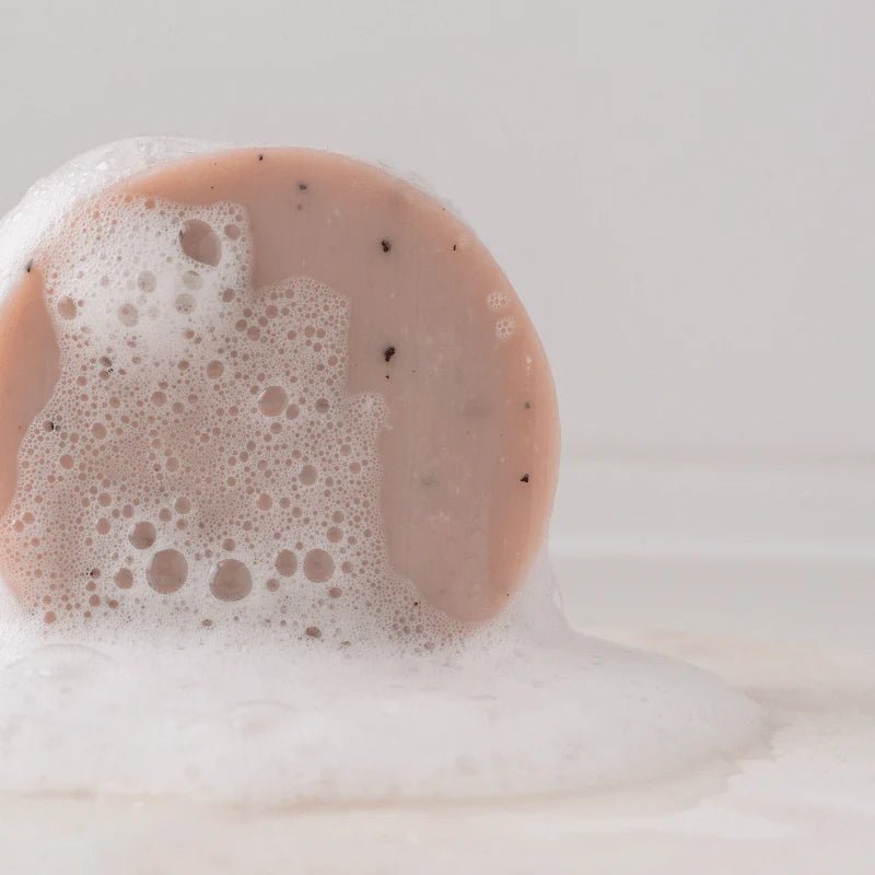 Seed & Sprout Rose Geranium body wash bar covered in rich, soapy lather and bubbles.