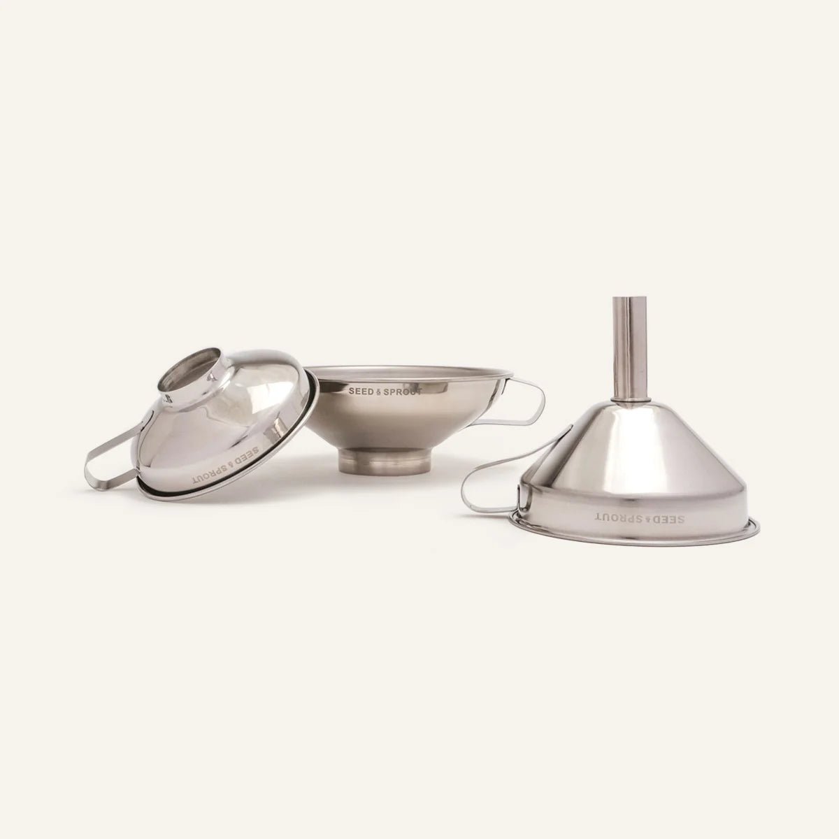 Seed & Sprout stainless steel funnel set of 3 displaying different sizes with engraved branding.