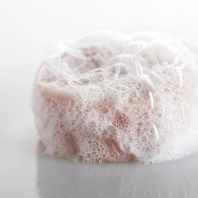 Seed & Sprout Rose Geranium solid shampoo bar covered in rich white soapy foam.