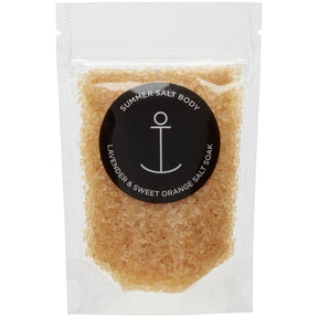 Summer Salt Body Lavender and Sweet Orange Salt Soak in clear resealable pouch with golden bath salts and black anchor logo